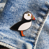 puffin pin badge on denim jacket