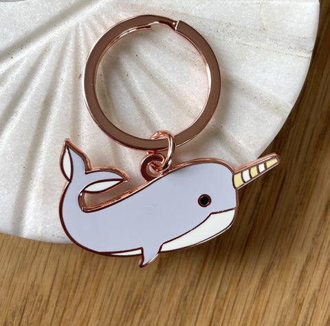Keychain with a narwhal design on a marble background